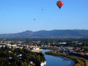 Morning over Napa river with hot air balloon in the background
